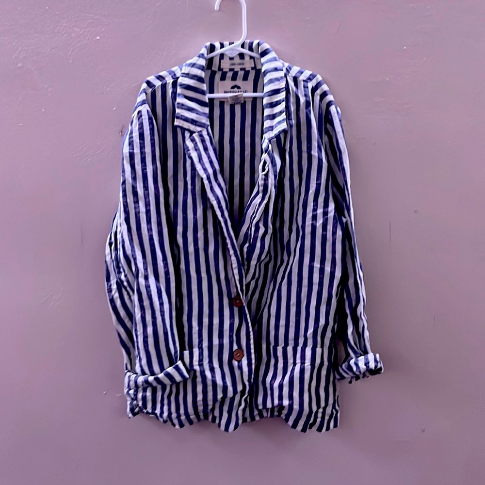 A %100 linen blue and white woman’s blazer in size medium.